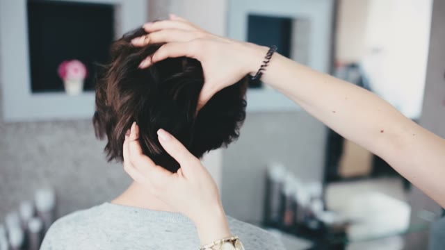 Hairdresser Touches The Client's Hair