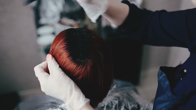 Girl Paints The Hair On The Client's Head