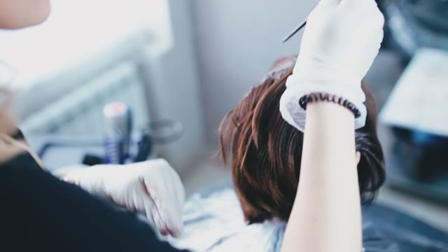 Girl Paints The Hair Roots With Hair Dye