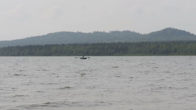 Man Swims In A Boat Downstream