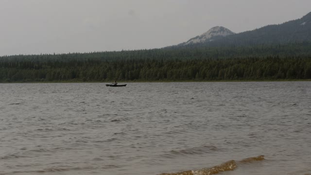 Man Is Concentrating And Swim In A Boat