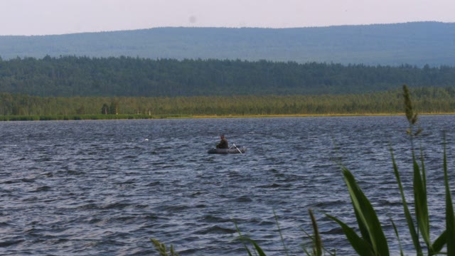 Man Sits In A Boat