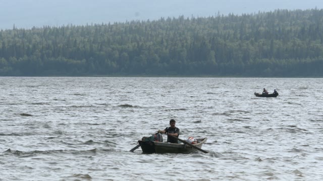 Man Rowing Oars In A Boat