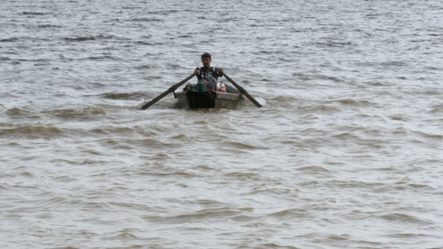 Man Is Swimming In A Boat