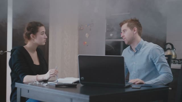 Guy With A Girl Is Sitting At The Laptop