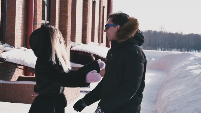 Girl Is Pushing The Guy Into The Snow