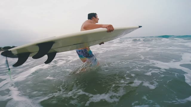 Guy With The Board Jumps On The Wave