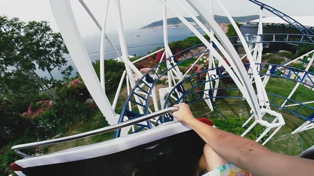 Guy Keeps His Hands On The Handrail On The Attraction