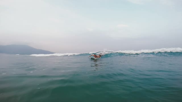 Guy Is Floating On The Board On The Wave