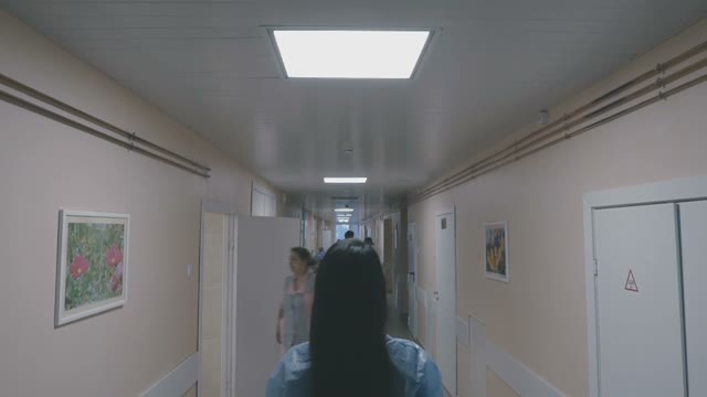 Girl Is Standing In The Middle Of A Hospital Corridor