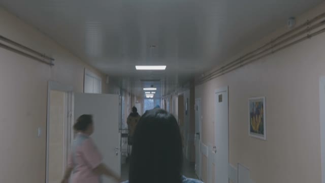 Girl Is Standing In The Hospital And Looks Ahead