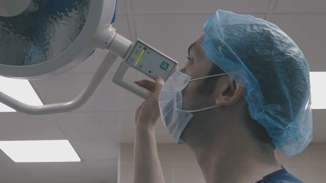 Doctor Turns On The Lamp And Looks At The Patient